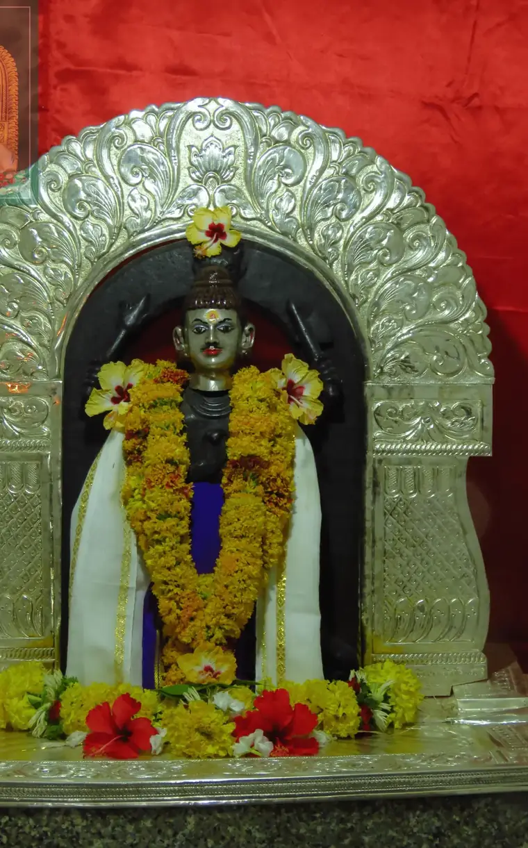 The idol of Shri Kalbhairav beneath a silver prabhavali